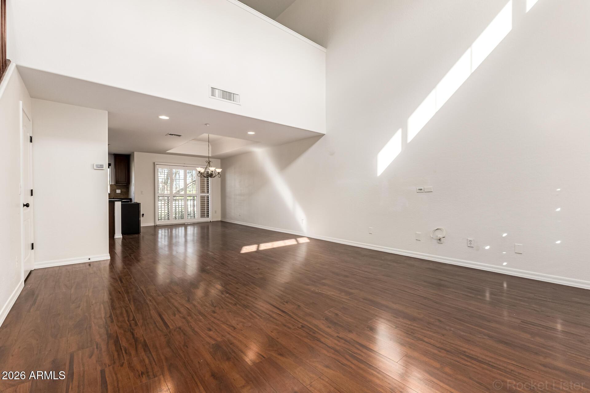 6940 East Cochise Road, Unit 1043 Paradise Valley, AZ 85253 - Photo 6 of 35 wooden floor in an empty room with a window