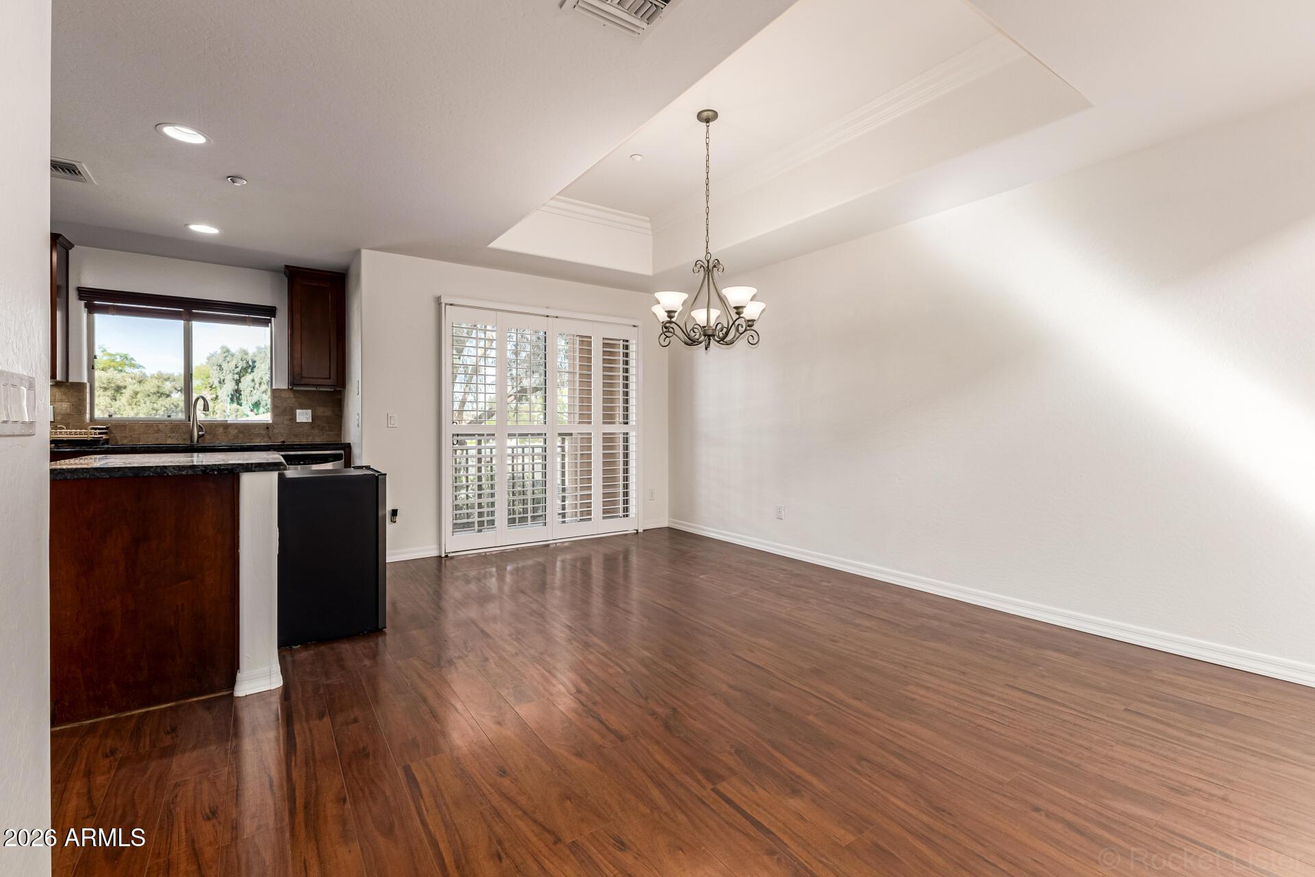 6940 East Cochise Road, Unit 1043 Paradise Valley, AZ 85253 - Photo 9 of 35 a view of a big room with wooden floor and windows