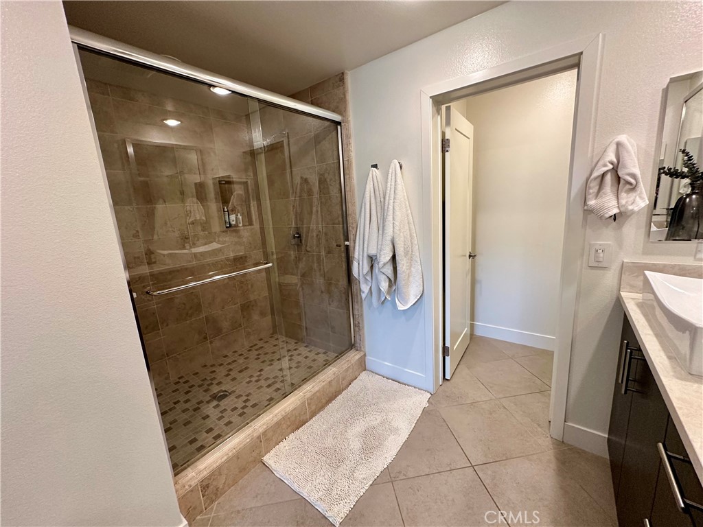 61 Gramercy Irvine, CA 92612 - Photo 12 of 33 a bathroom with a glass shower door
