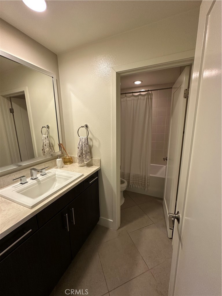 61 Gramercy Irvine, CA 92612 - Photo 16 of 33 a bathroom with a double vanity sink a toilet and a mirror