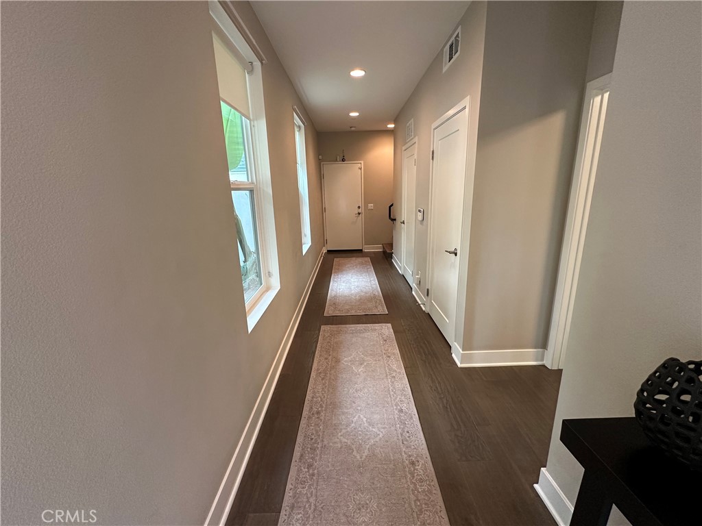 61 Gramercy Irvine, CA 92612 - Photo 20 of 33 a view of a hallway with wooden floor and staircase