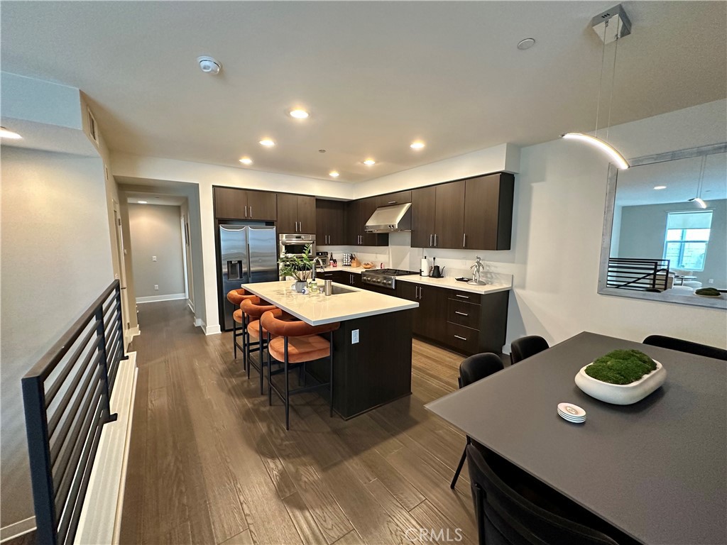 61 Gramercy Irvine, CA 92612 - Photo 2 of 33 a open kitchen with stainless steel appliances granite countertop a sink a stove a dining table and chairs