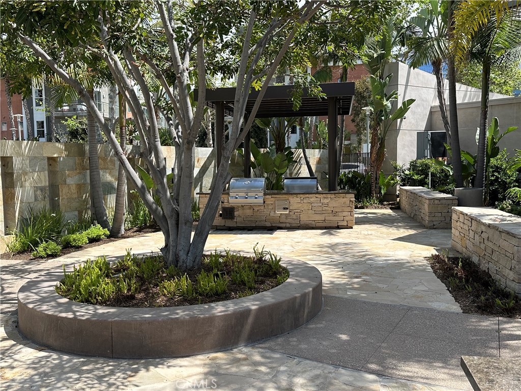 61 Gramercy Irvine, CA 92612 - Photo 25 of 33 a view of a backyard with potted plants and large trees