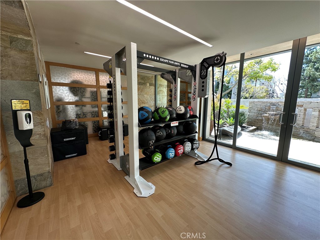 61 Gramercy Irvine, CA 92612 - Photo 31 of 33 a view of a room with gym equipment and large windows