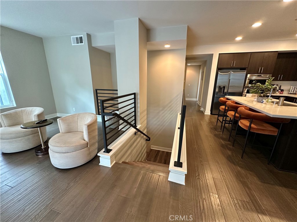 61 Gramercy Irvine, CA 92612 - Photo 4 of 33 a living room with furniture and a wooden floor