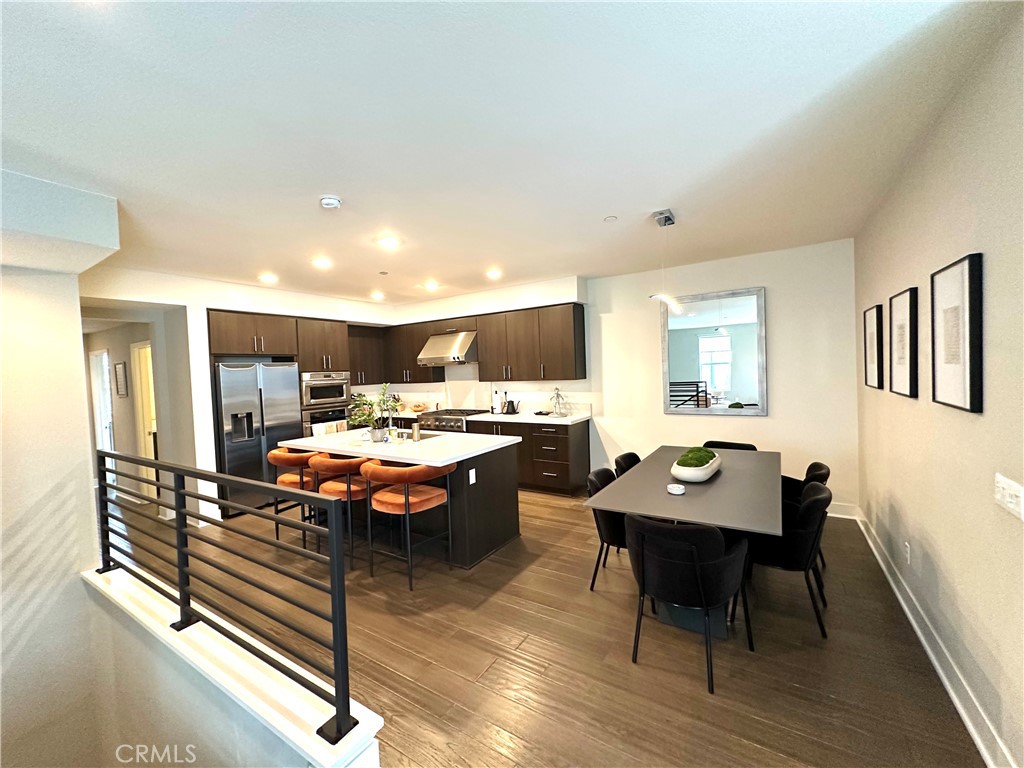 61 Gramercy Irvine, CA 92612 - Photo 5 of 33 a living room with stainless steel appliances furniture a rug and a kitchen view