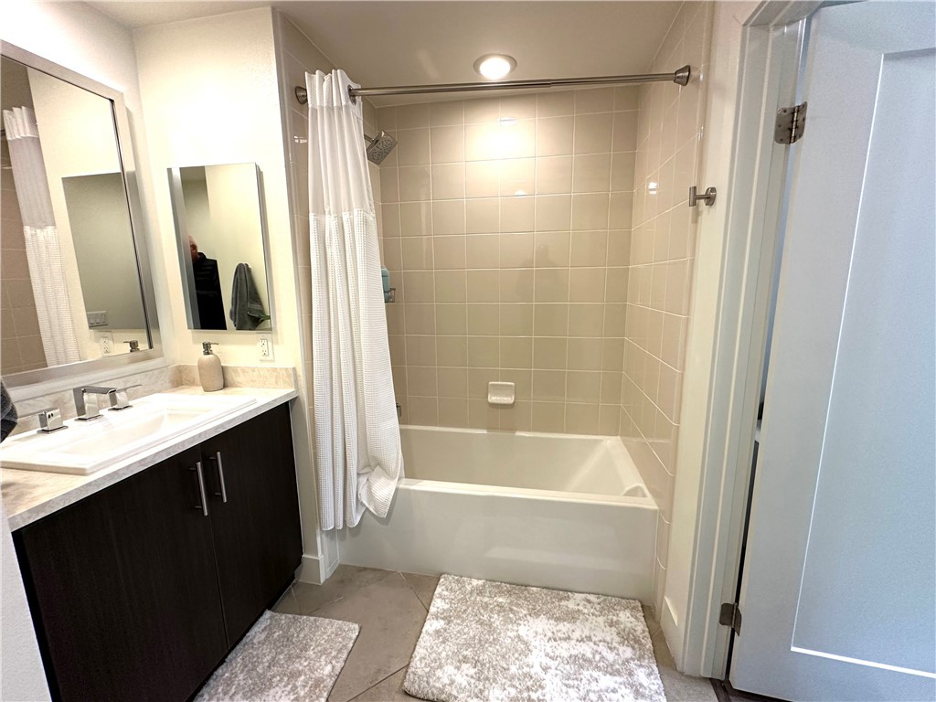 61 Gramercy Irvine, CA 92612 - Photo 10 of 33 a bathroom with a bathtub shower sink vanity and a mirror