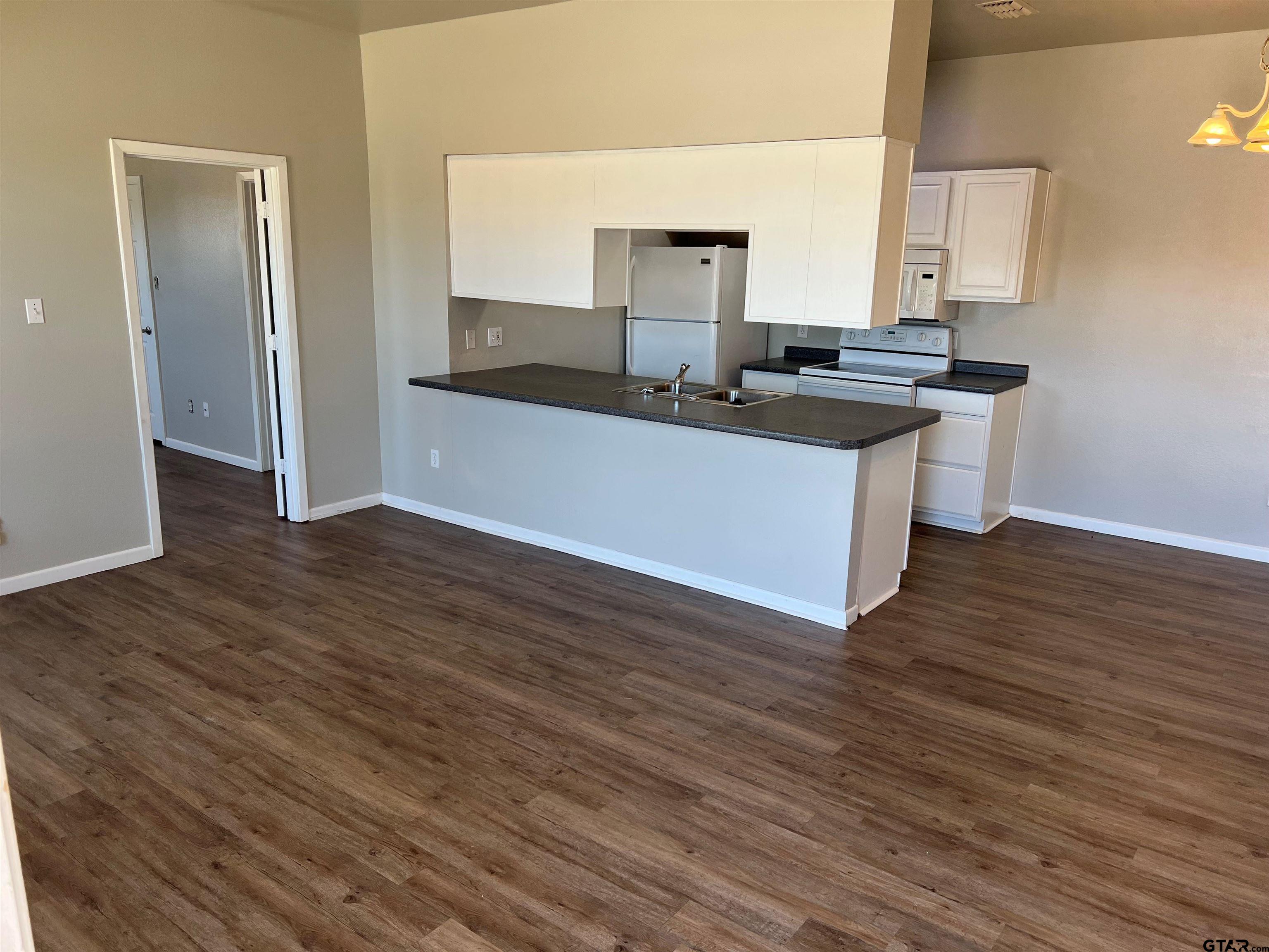 19038 FM 2493 Flint, TX 75762 - Photo 3 of 10 a kitchen with granite countertop a sink and a stove top oven