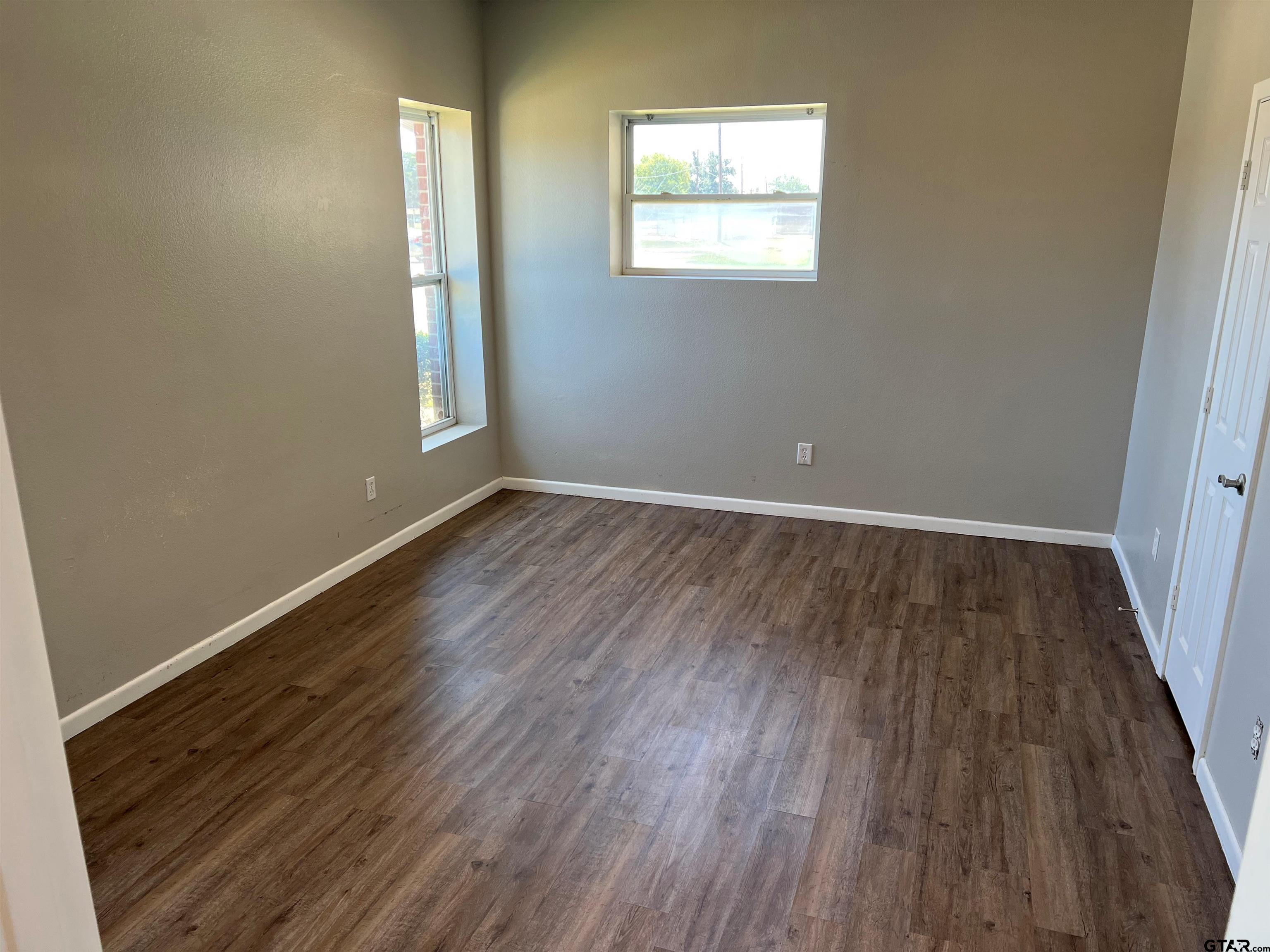 19038 FM 2493 Flint, TX 75762 - Photo 6 of 10 an empty room with wooden floor and windows