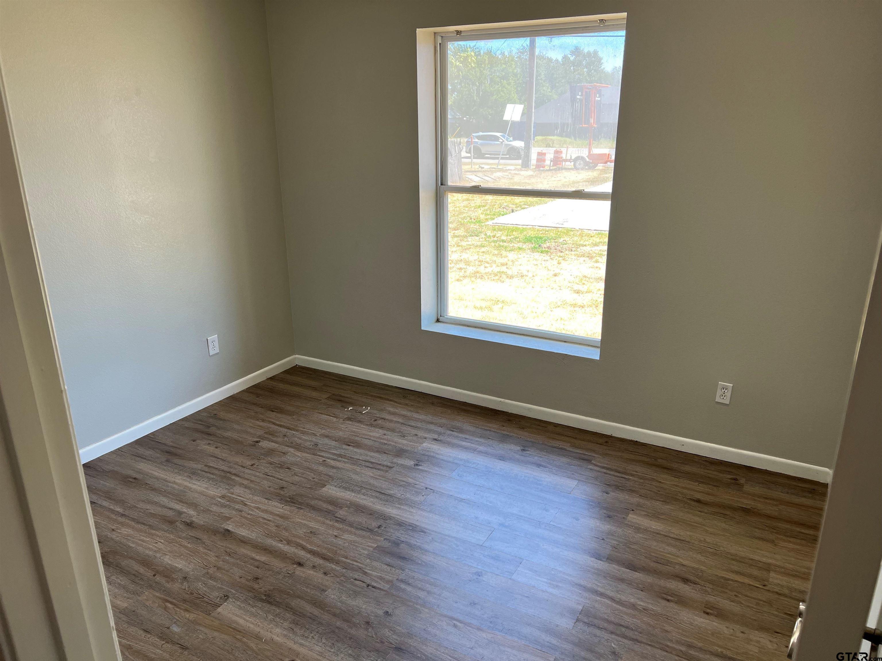 19038 FM 2493 Flint, TX 75762 - Photo 10 of 10 an empty room with wooden floor and windows