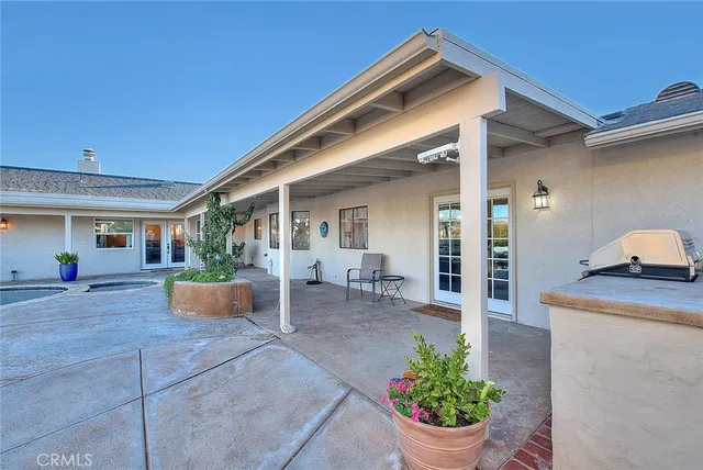 a view of a dry yard with wooden fence