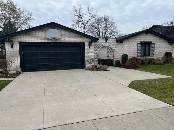 a view of a house with a yard and garage