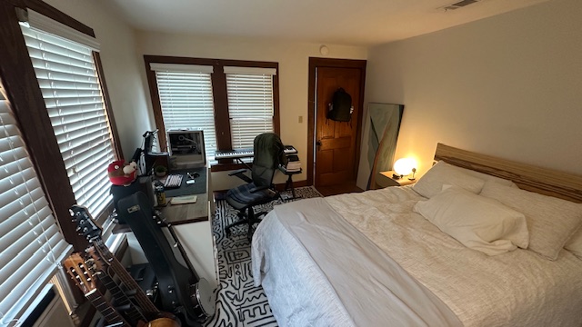 906 West 22nd Street, Unit 4 Austin, TX 78705 - Photo 6 of 7 a bed sitting in a bedroom next to a window