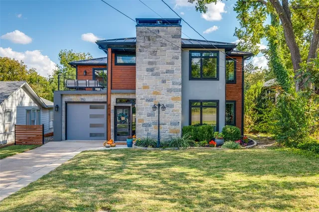 a view of a brick house with a large windows and a yard