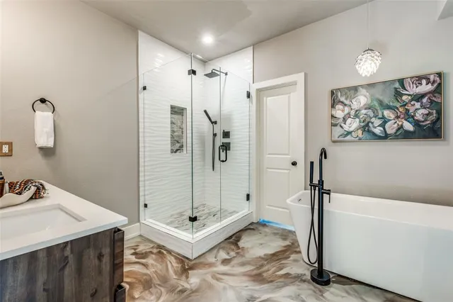 a bathroom with a tub a sink and a shower