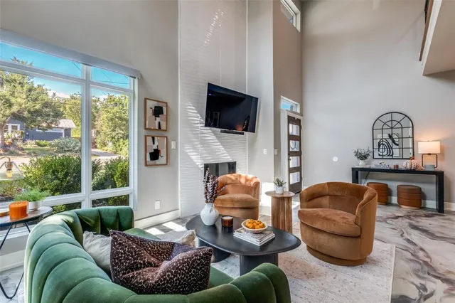 a living room with furniture a fireplace and a flat screen tv