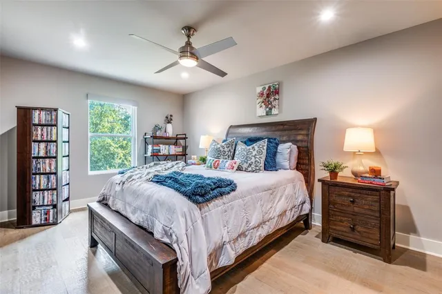 a bedroom with a large bed and a chandelier