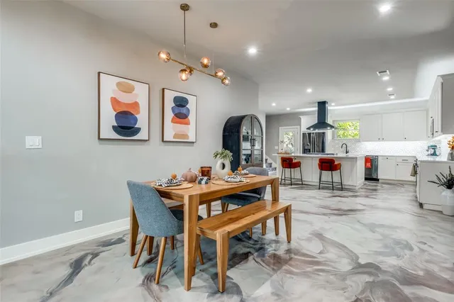 a living room with lots of furniture and kitchen view