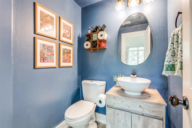 a bathroom with a toilet a sink and a mirror