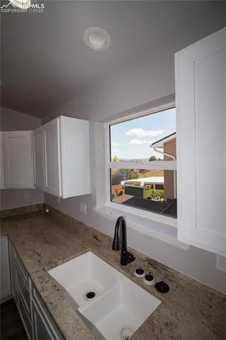 a kitchen with a refrigerator and a sink