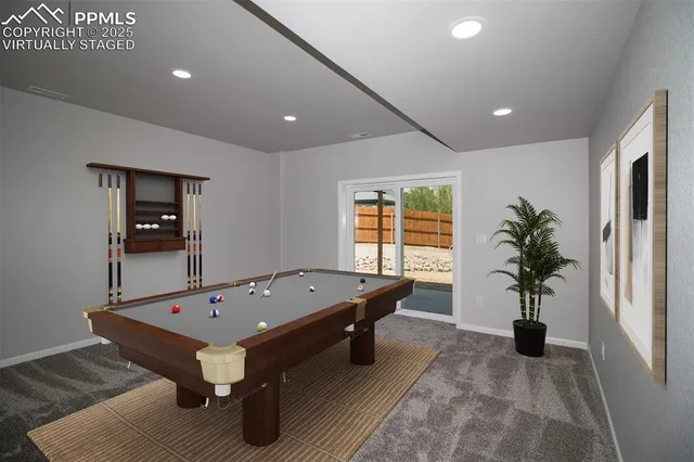 a room with furniture pool table and potted plants