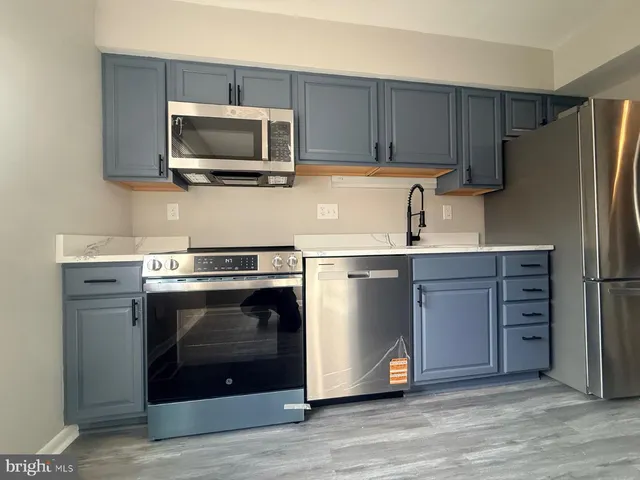a kitchen with a stove microwave and refrigerator