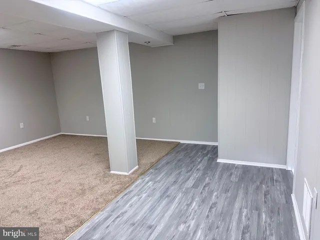 a view of room with wooden floor