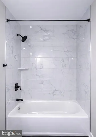 a bathroom with a shower and a bath tub