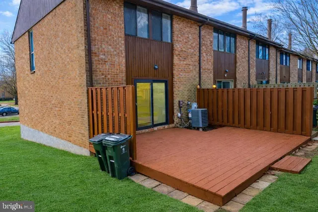 a view of a backyard with wooden fence