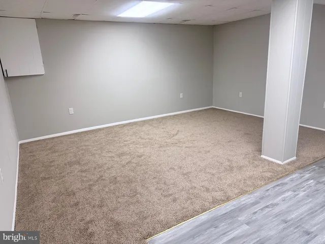 an empty room with wooden floor and closet