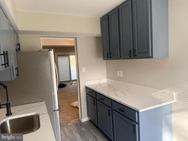 a kitchen with a sink and a refrigerator