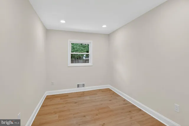 a view of room with hardwood floor and window