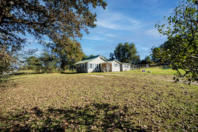 a view of house with a yard
