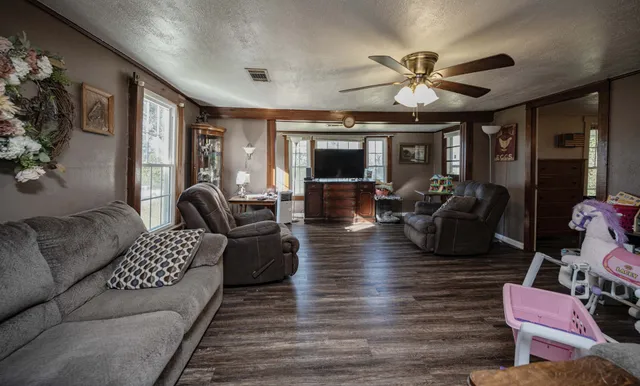 a living room with furniture and wooden floor