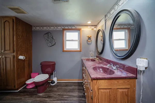 a bathroom with a toilet mirror vanity and toilet