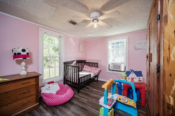 a bedroom with furniture and wooden floor