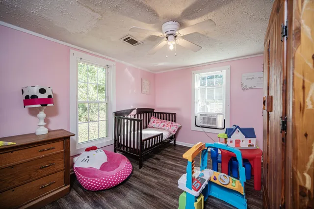 a bedroom with furniture and wooden floor