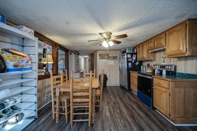 a view of a dining room with furniture a chandelier and wooden floor
