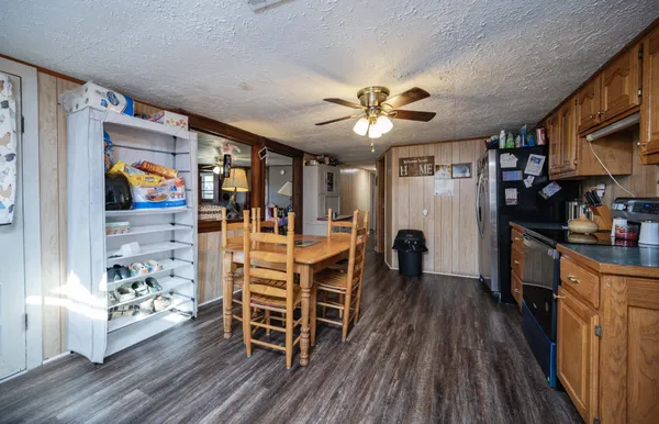 a kitchen with wooden floors and wooden cabinets