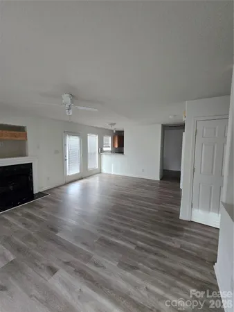 a big room with wooden floor and windows