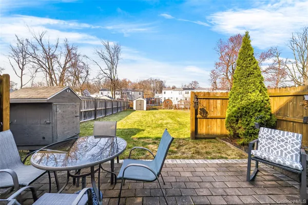 a view of a patio with iron fence