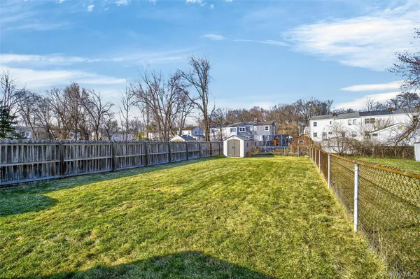 a view of a garden with a building in the background