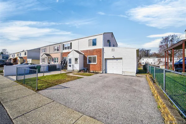 a view of house with outdoor space and parking
