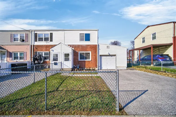 a front view of residential houses with yard