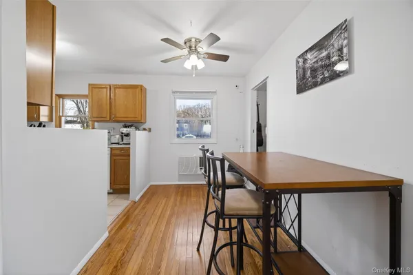 a dining room with furniture and wooden floor