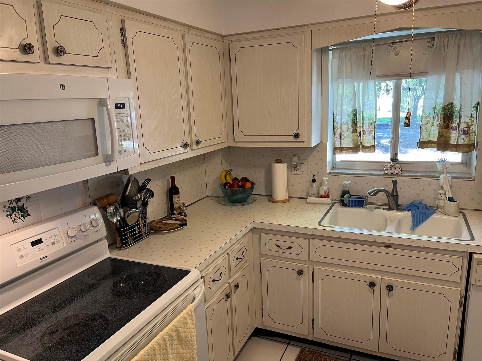 412 South Luna Court, Unit 2 Hollywood, FL 33021 - Photo 15 of 20 a kitchen with white cabinets and white appliances