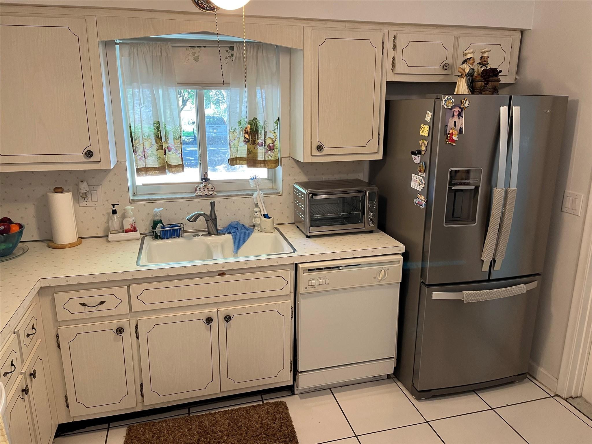 412 South Luna Court, Unit 2 Hollywood, FL 33021 - Photo 16 of 20 a kitchen with white cabinets and white appliances