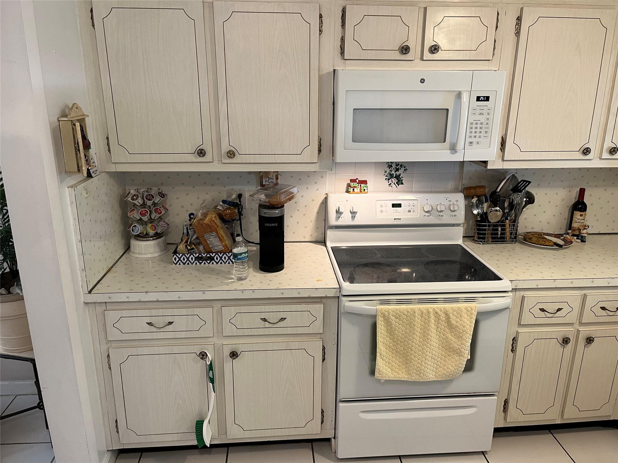 412 South Luna Court, Unit 2 Hollywood, FL 33021 - Photo 17 of 20 a kitchen with white cabinets and appliances