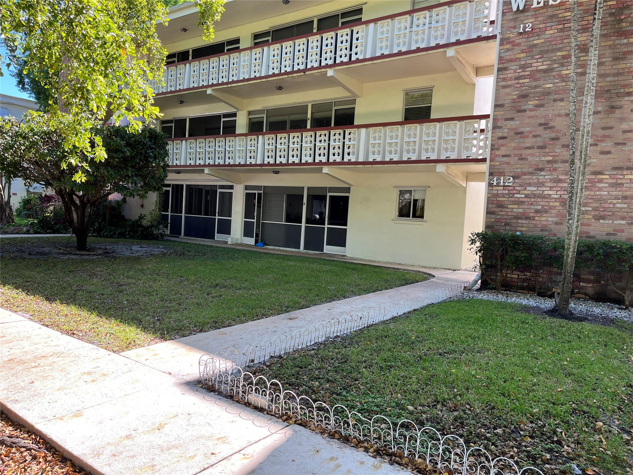 412 South Luna Court, Unit 2 Hollywood, FL 33021 - Photo 2 of 20 front view of a house with a yard