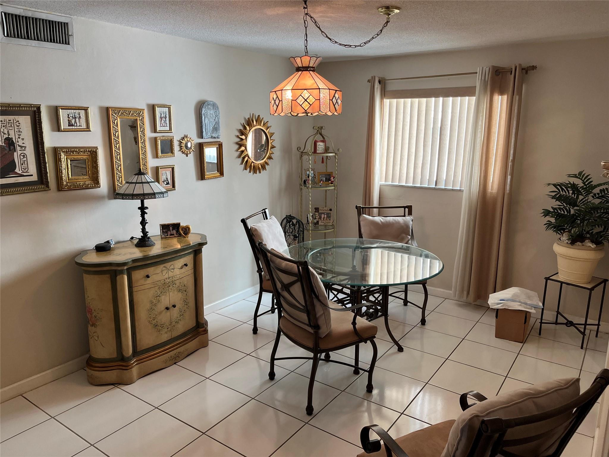 412 South Luna Court, Unit 2 Hollywood, FL 33021 - Photo 6 of 20 a dining room with furniture a chandelier and wooden floor